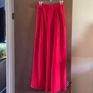 Red trousers with tie. Not stretchy in the waist. Size s